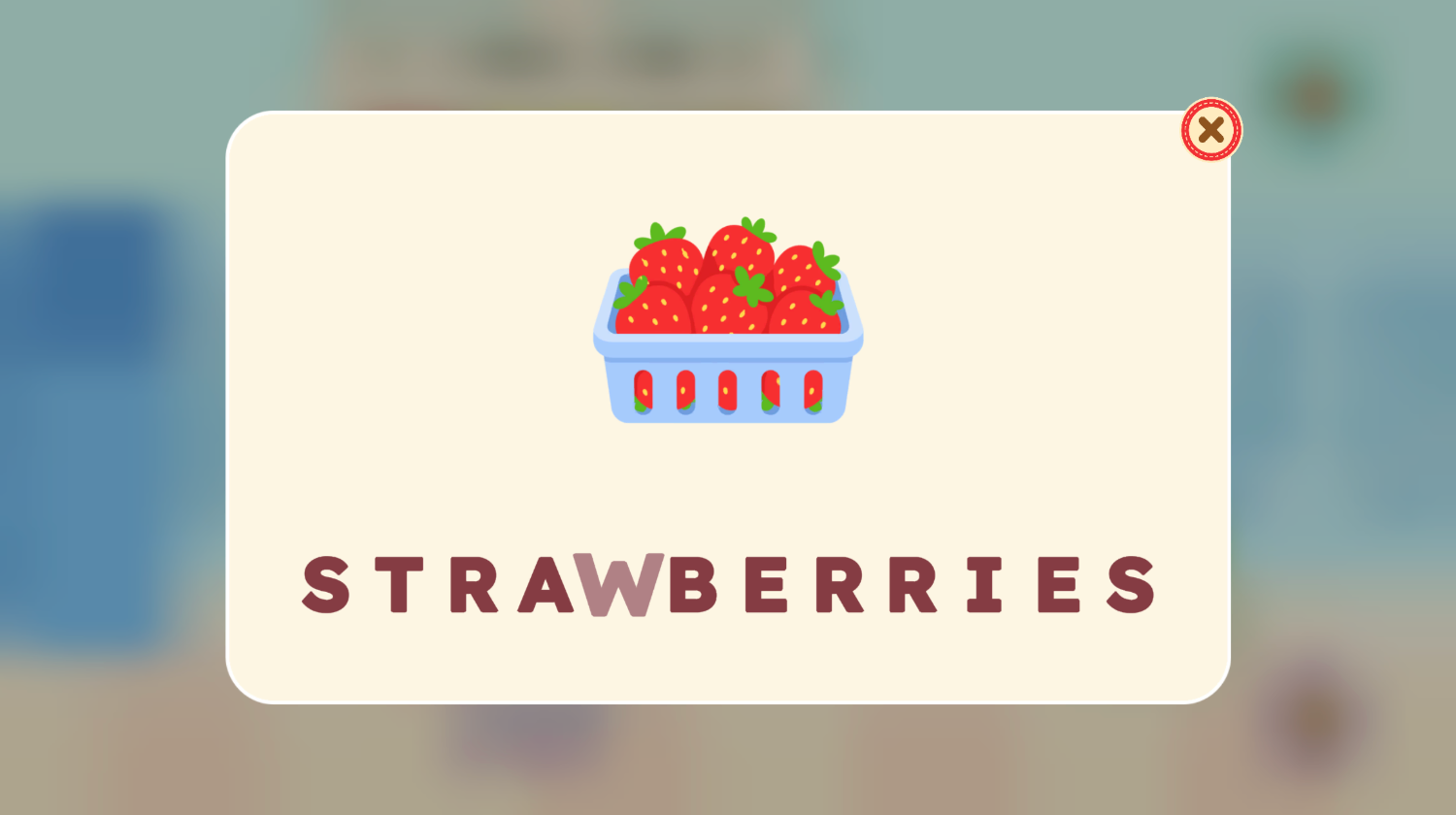 A word card reading STRAWBERRIES with one letter highlighted as it is sounded out