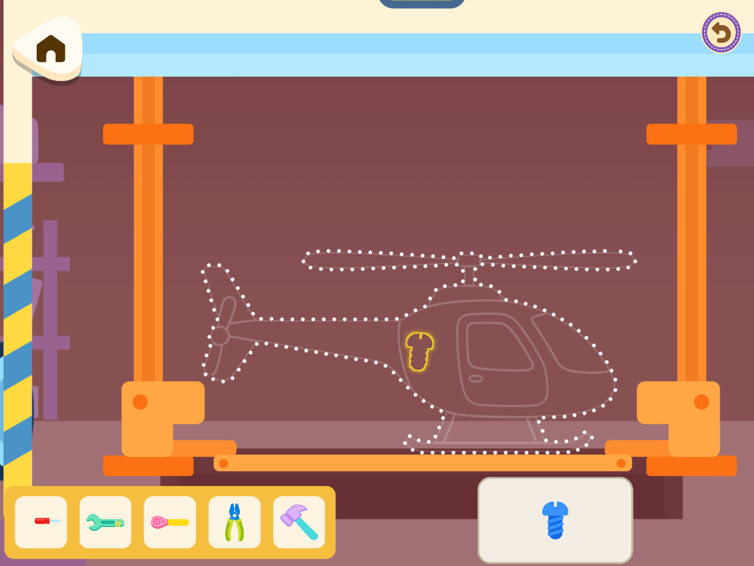 Vroom's workshop, with a dotted helicopter outline waiting for parts and a tray of tools
